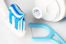 toothbrush with toothpaste and dental floss